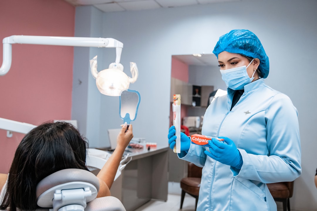 Dentist teaching child proper brushing technique
