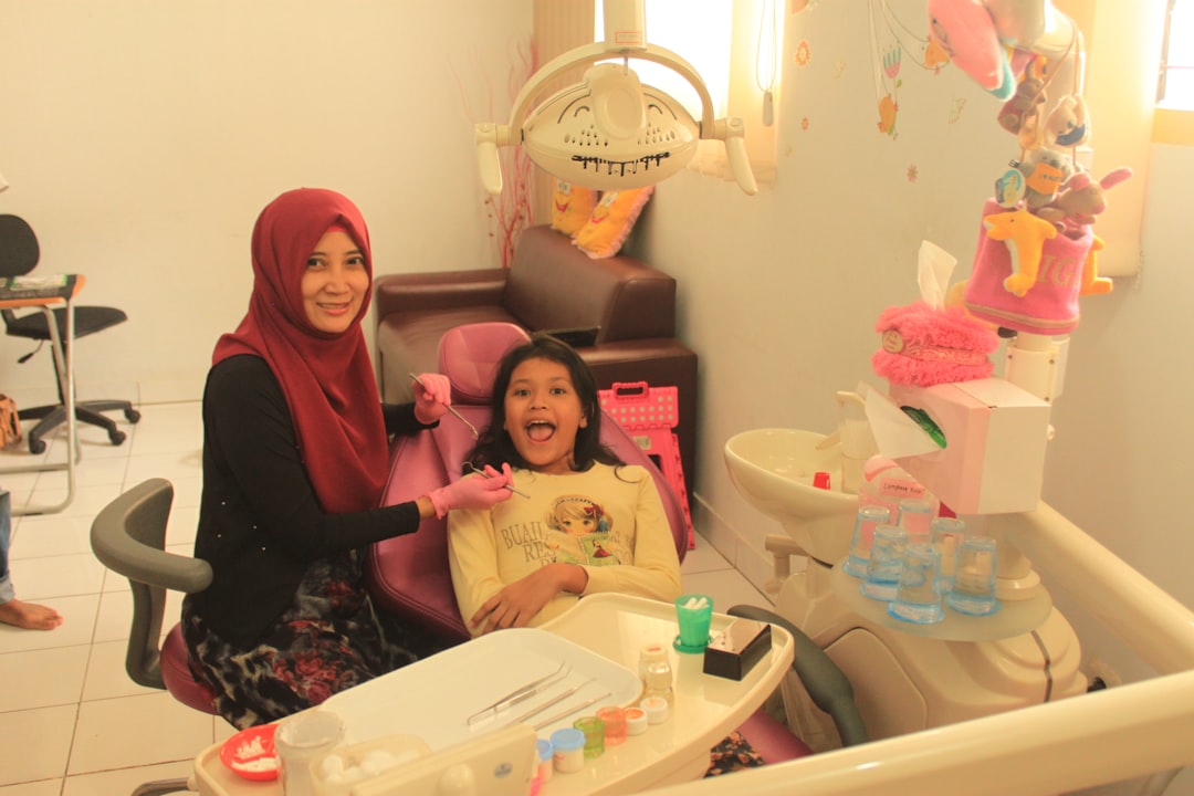 Happy child at dentist with parent, showing comfortable dental experience